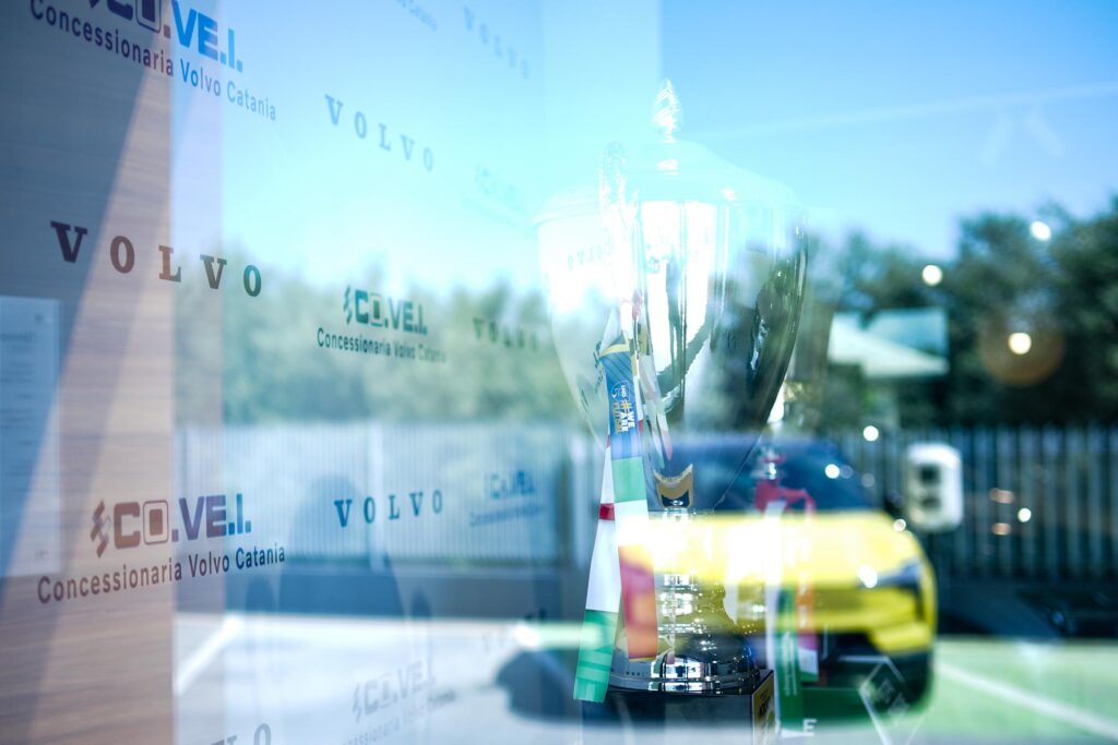 vetrina covei volvo cars con la coppa italia della covei metacatania bricocity e nel riflesso una Volvo EX30 gialla